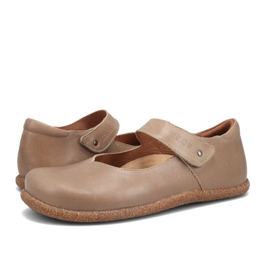 Pair of beige shoes with a strap on a white background